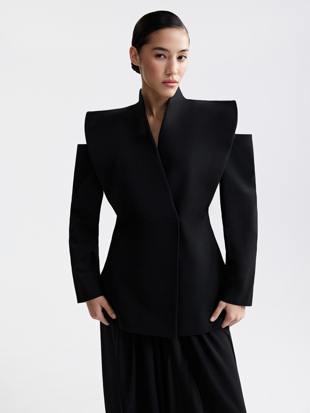 Black jacket with hidden button closure, side view