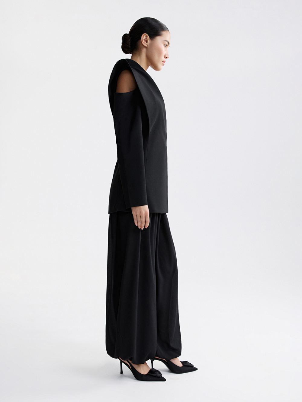 Black architectural jacket, back view