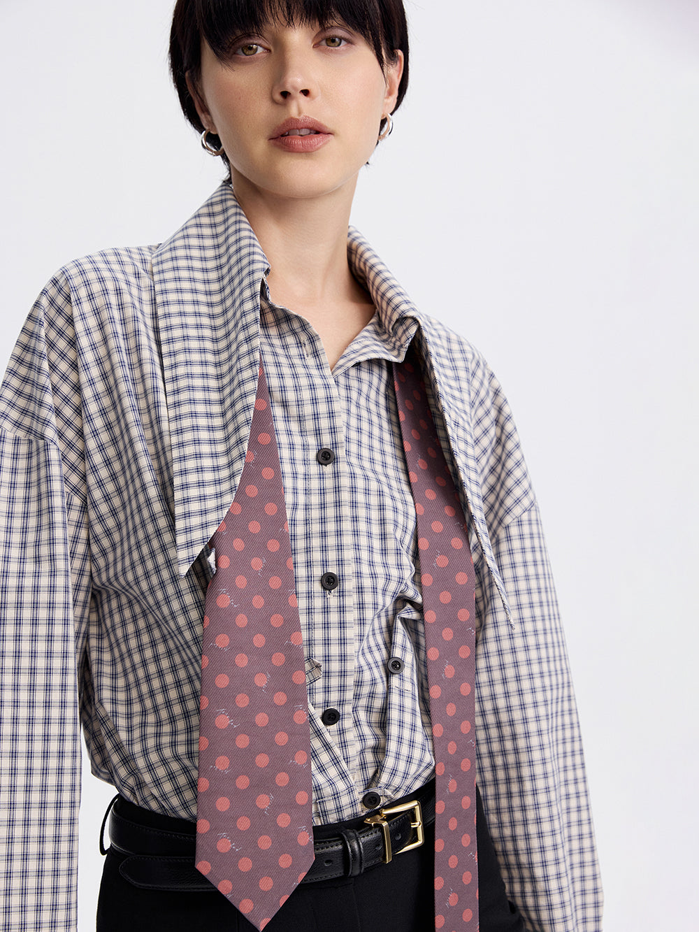 Polka dot silk-lined tie styled on a checked shirt