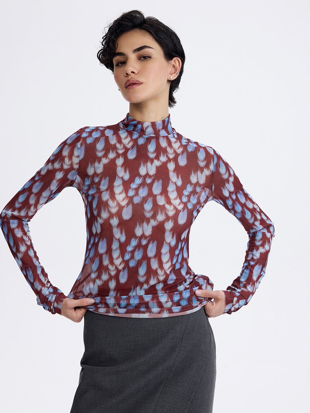 PRAS printed mesh top in burgundy and blue, hands on hips