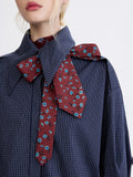 Silk-lined tie with blue floral print, styled on a checked shirt