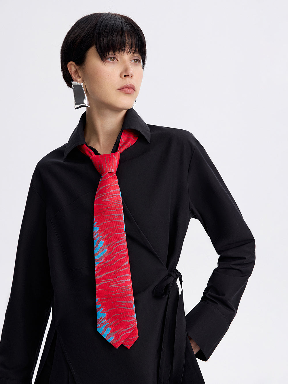 Red tiger-stripe silk-lined tie on a black shirt