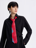 Red tiger-stripe silk-lined tie on a black shirt